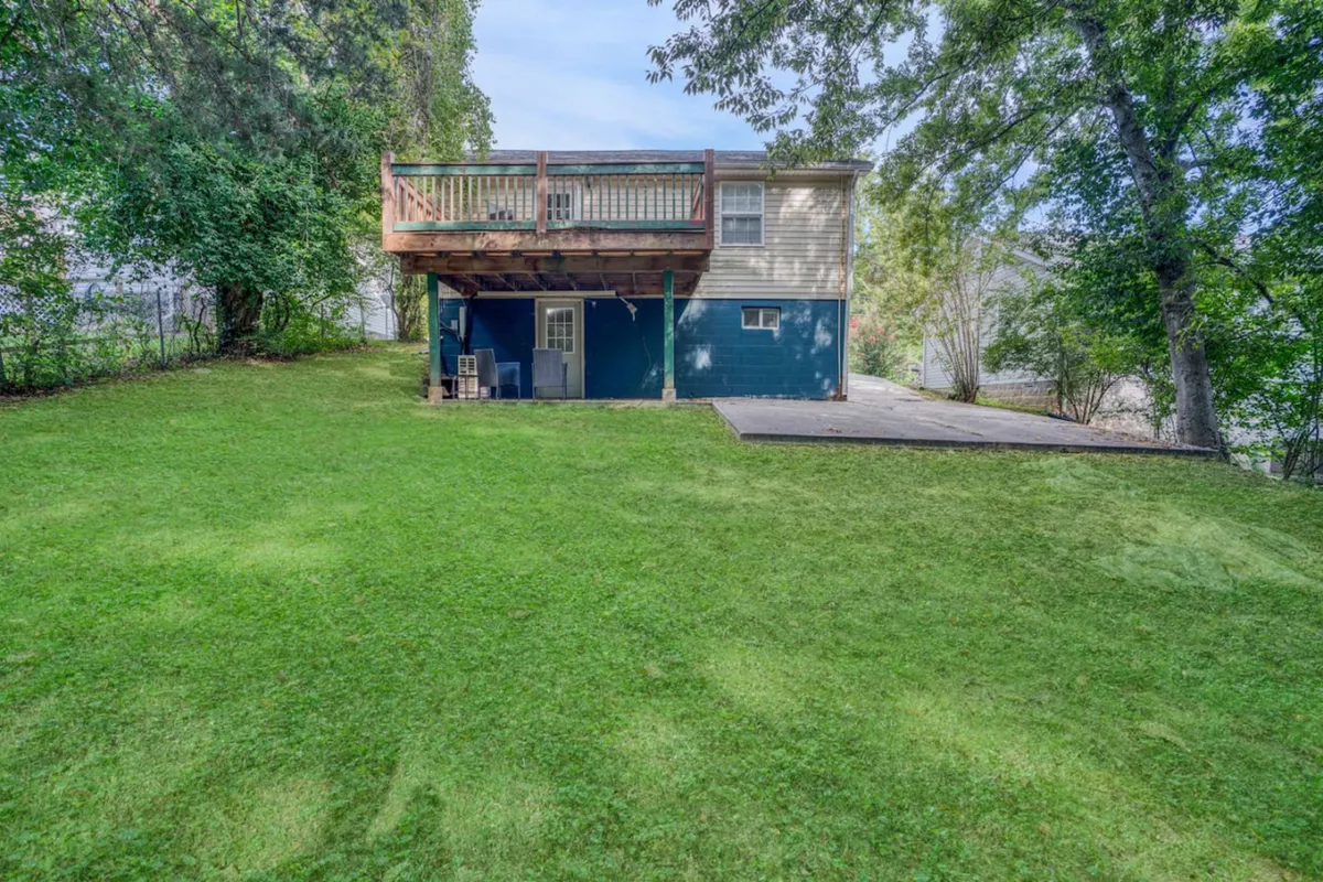 The photo showcases a spacious deck overlooking a lush green lawn and the exterior of the house. The open outdoor area conveys a sense of relaxation and readiness to embark on a day of urban exploration.